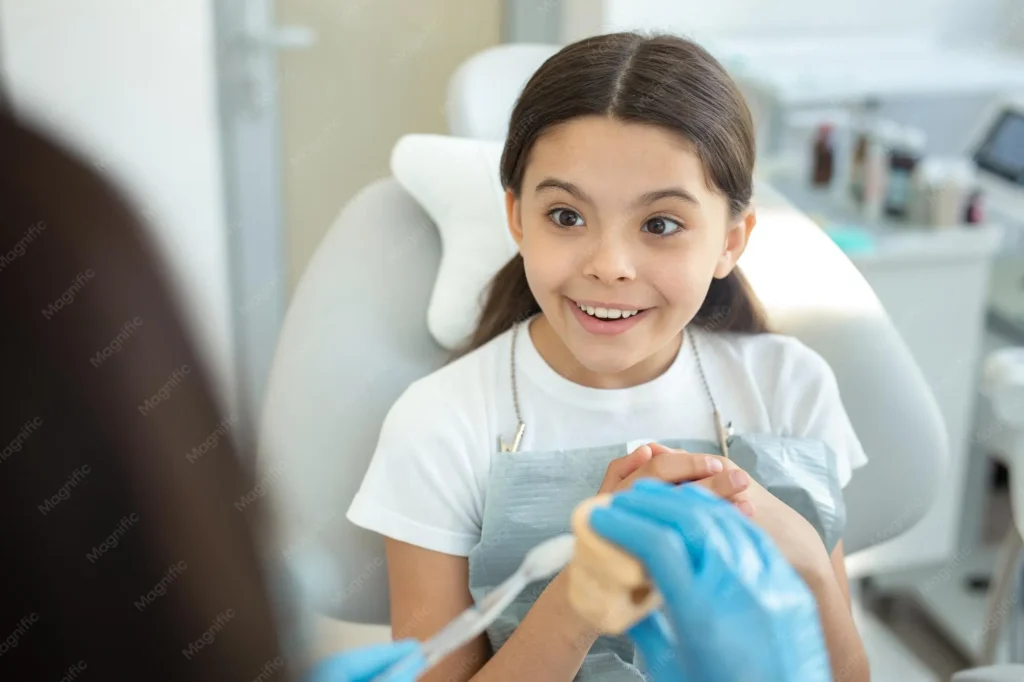 Child smiling during a pediatric dental visit in Birmingham AL