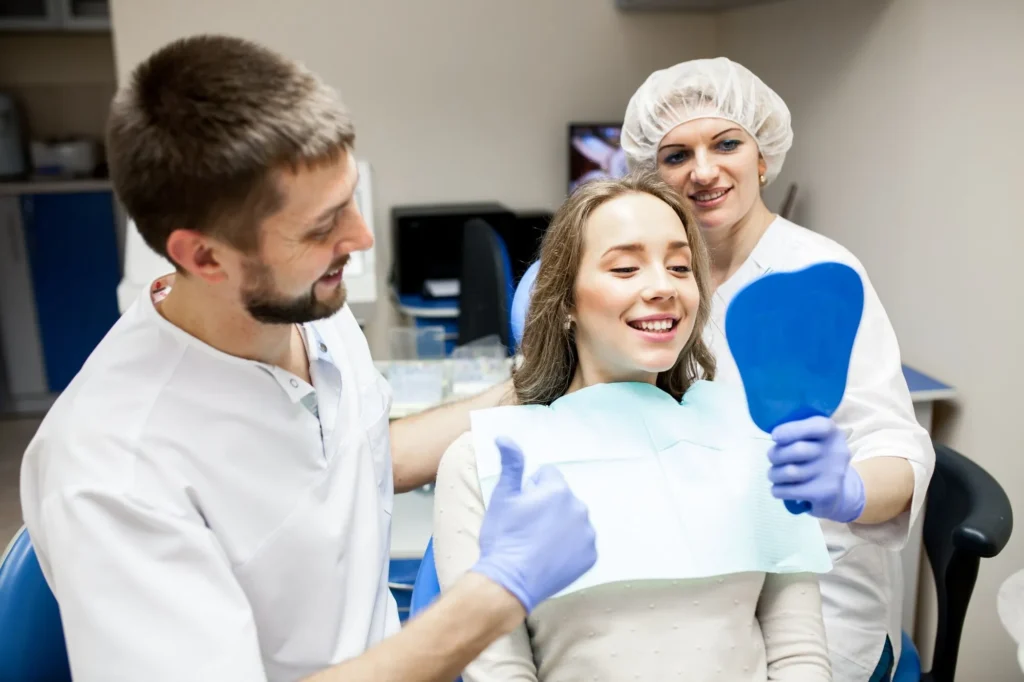Happy family with pediatric dentist after successful dental visit